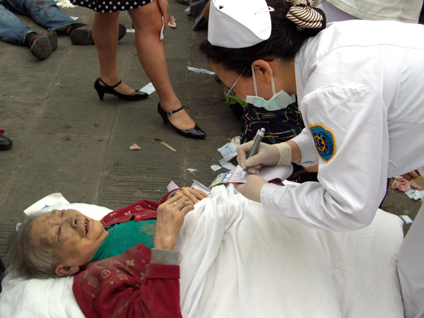An old woman accepts medical treatment