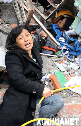 5月13日，四川绵竹县汉旺镇一所在地震中倒塌的中学废墟中，一位母亲在呼唤尽快救出埋在废墟中的儿子。  ...